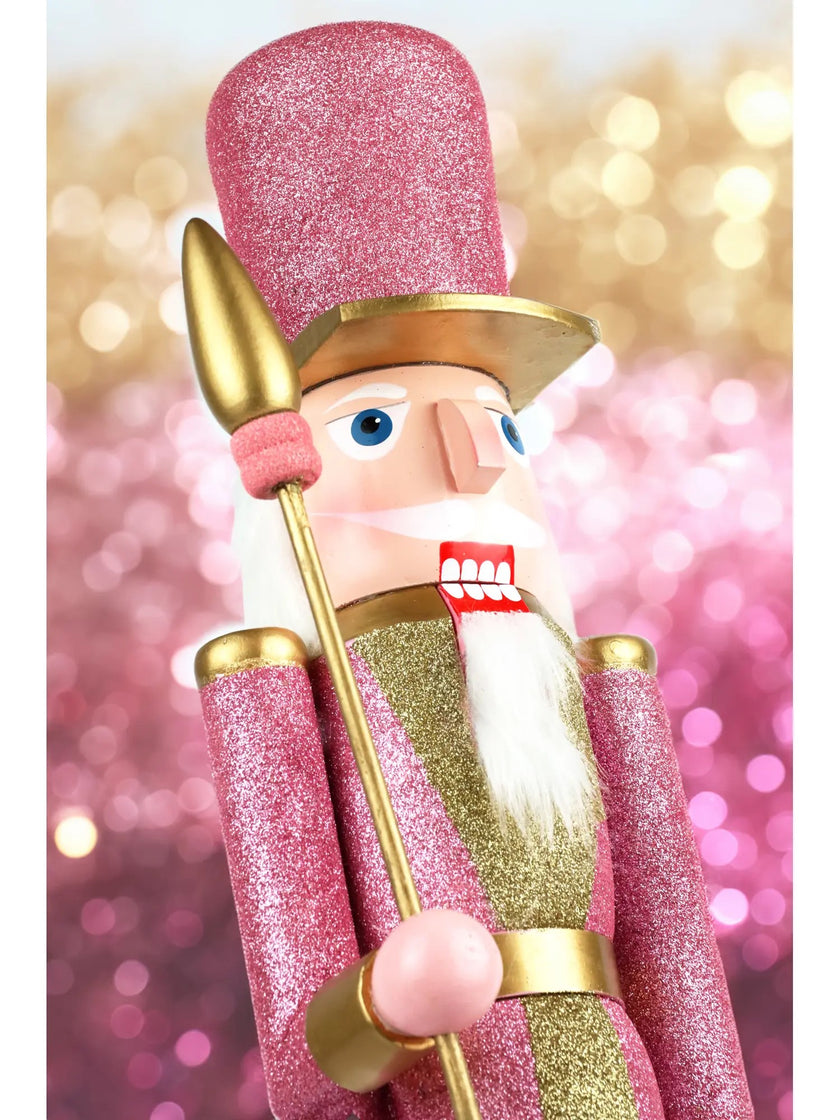 Spărgător de nuci roz cu sclipici și sceptru auriu din prim plan